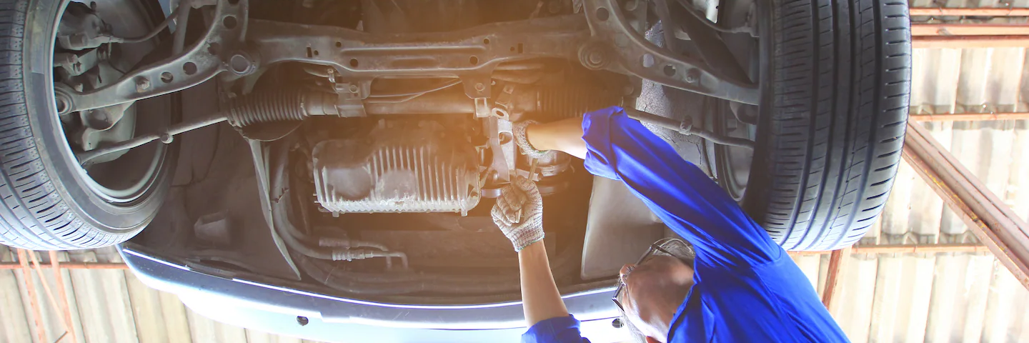 Service Technician working under a Honda