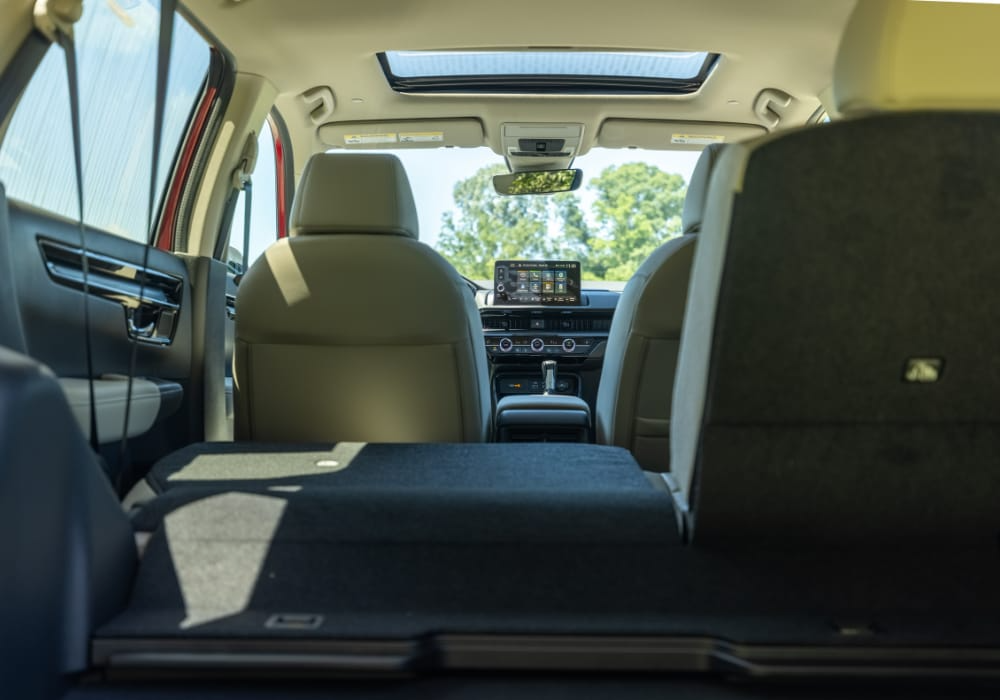 Cargo space in the back of a 2025 Honda CR-V. Middle row of seats is partially folded down